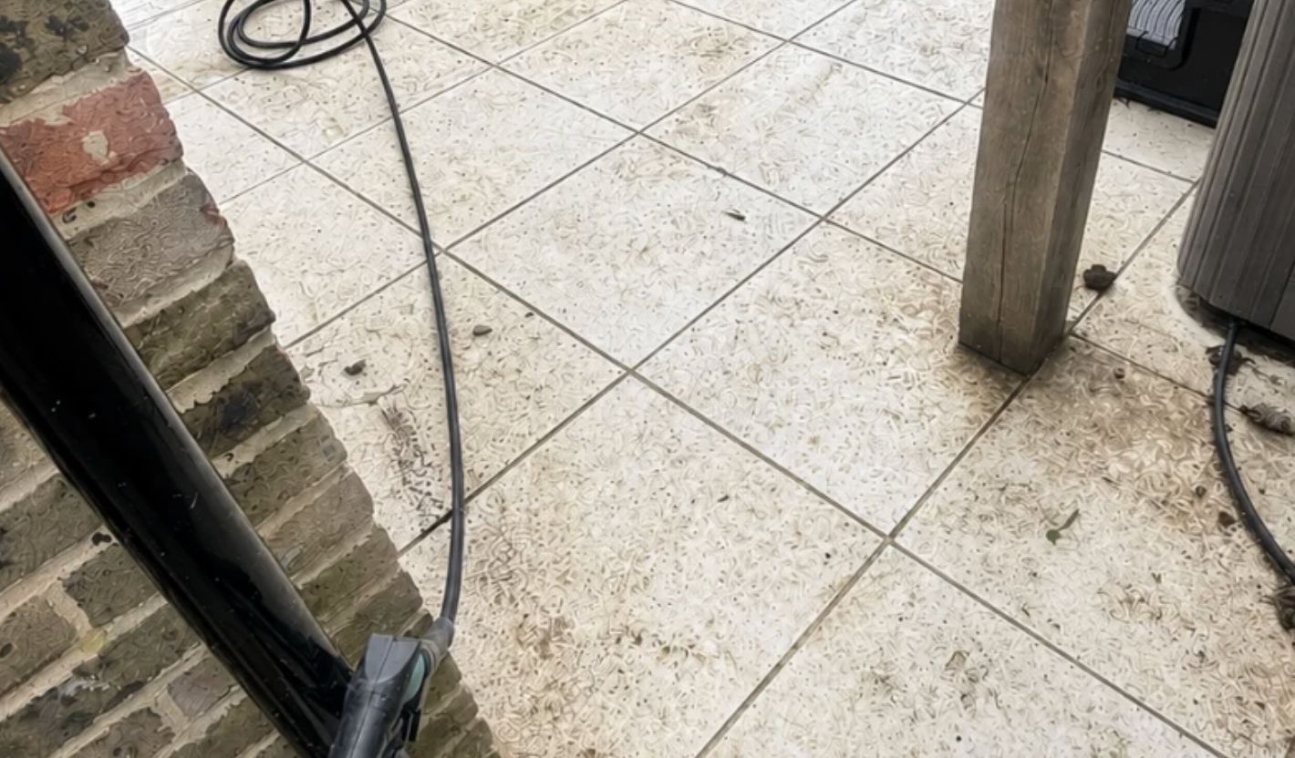 Dirty patio tiles before cleaning