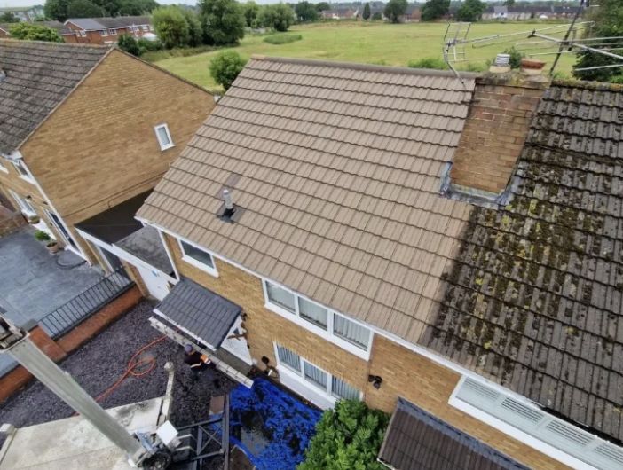 Aerial view of a roof part cleaned of moss